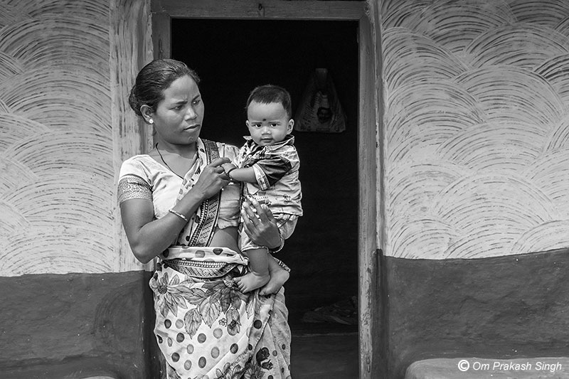 A woman beneficiary from a Particularly Vulnerable Tribal Group (PVTG) utilizing her saved time in childcare in Latehar district, Jharkhand, India